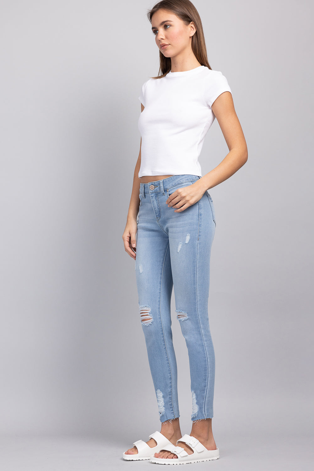 Distressed Mid Rise Skinny Jeans with Chewed Hems