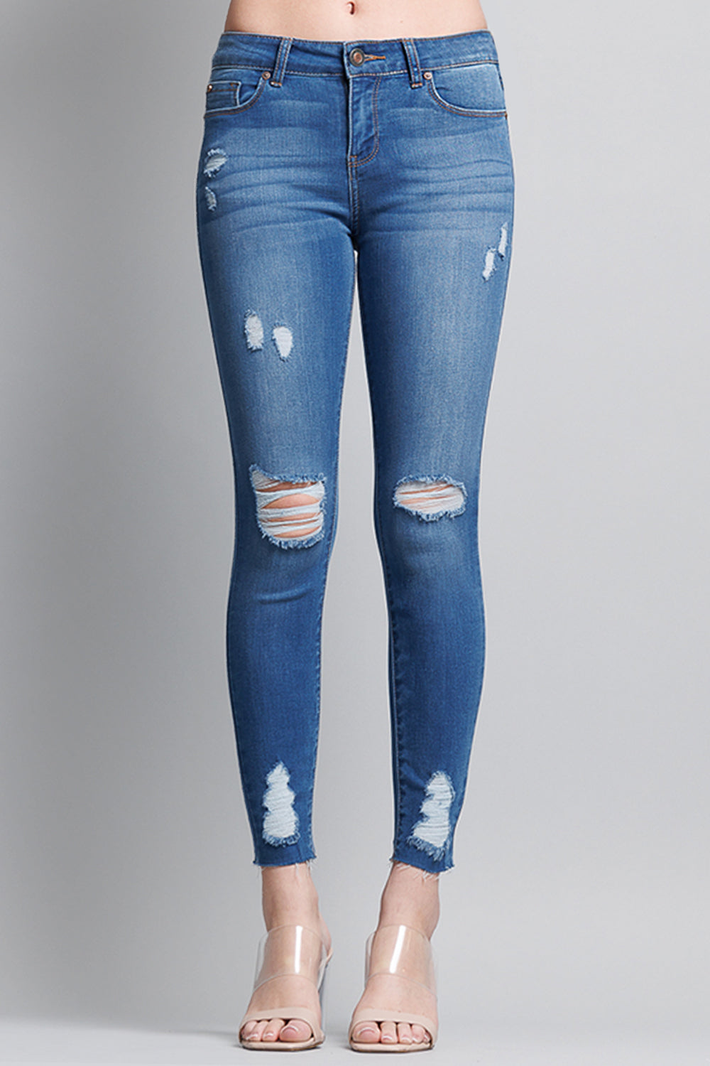 Shop Distressed Mid Rise Skinny Jeans with Chewed Hems