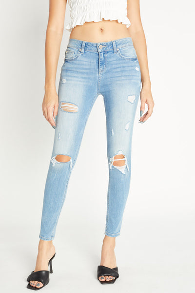 Jeans ajustados al tobillo de tiro medio desgastados