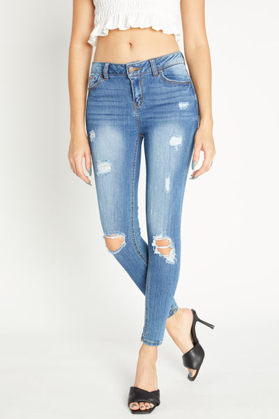 Jeans ajustados al tobillo de tiro medio desgastados