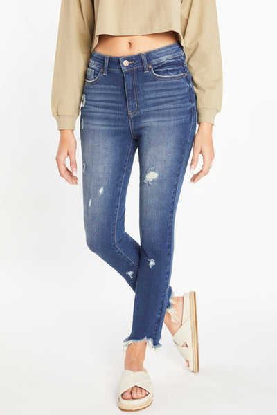 Pantalón pitillo de tiro superalto con dobladillo deshilachado muy masticado